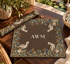 Mahjong mat dust bag, Brown with Pelicans design, shown with a matching monogrammed mahjong mat on a wood table