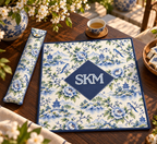 Mahjong mat dust bag, Blue & Green Chinoiserie design, shown with a matching monogrammed mahjong mat on a wood table