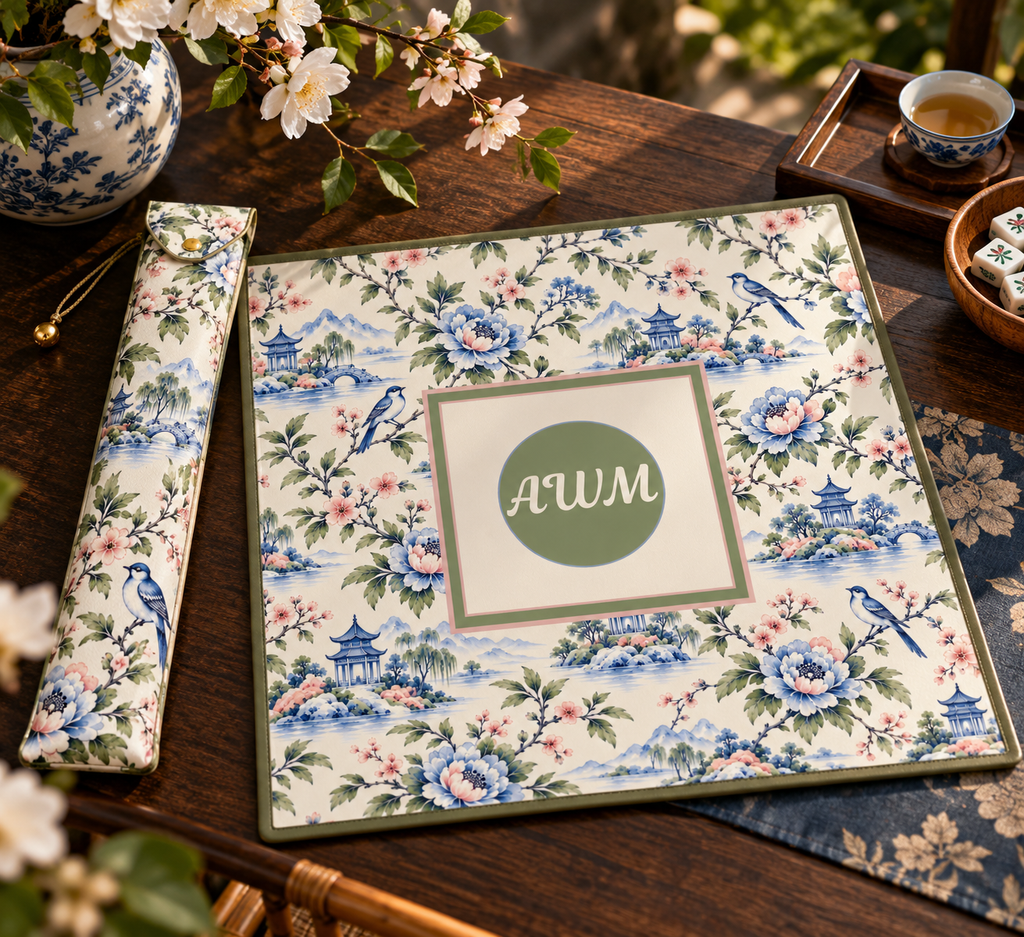 Mahjong mat dust bag, Blue, Green & Pink Chinoiserie design, shown with a matching monogrammed mahjong mat on a wood table