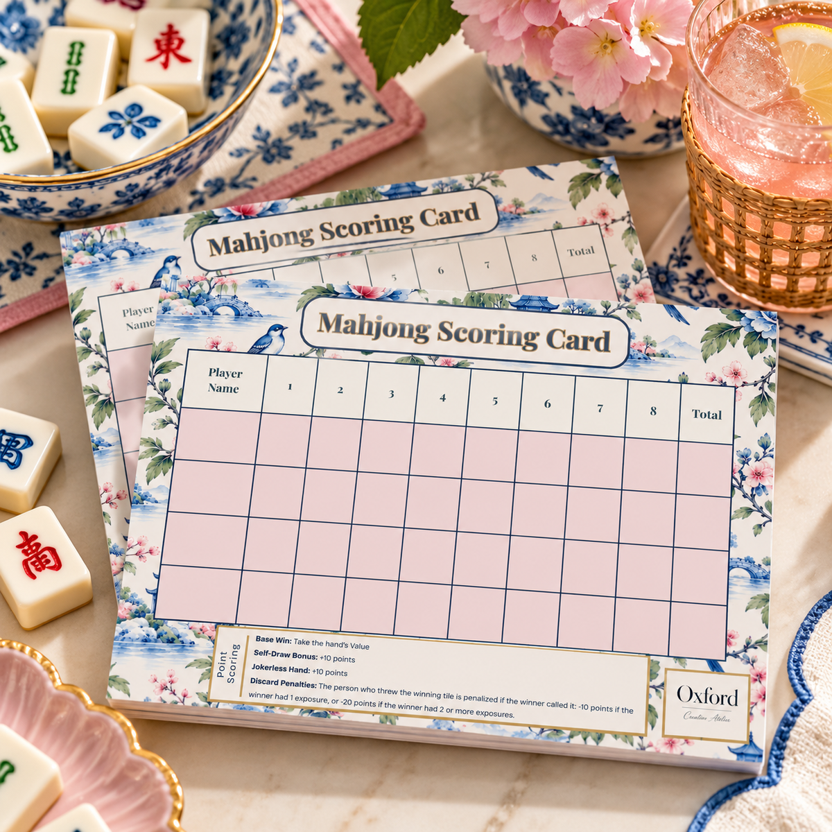Mahjong scorecard notepads for points on a game-night table, Pink Chinoiserie and Blue Herons designs