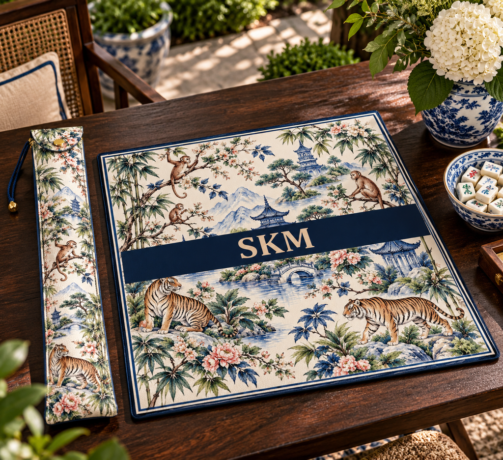 Mahjong mat dust bag, Tigers & Monkeys design, shown with a matching monogrammed mahjong mat on a wood table