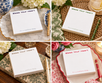 Bless Your Heart notepads in red, green, blue, and gray