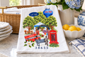 A Love Letter to Oxford flour sack tea towel folded on a marble counter with lemons and blue and white china