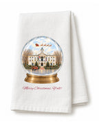 White flour sack tea towel folded, printed with a snow globe of the courthouse on the Square in Oxford with Santa's sleigh overhead, a red truck out front, and Merry Christmas, Y'all! in red script.
